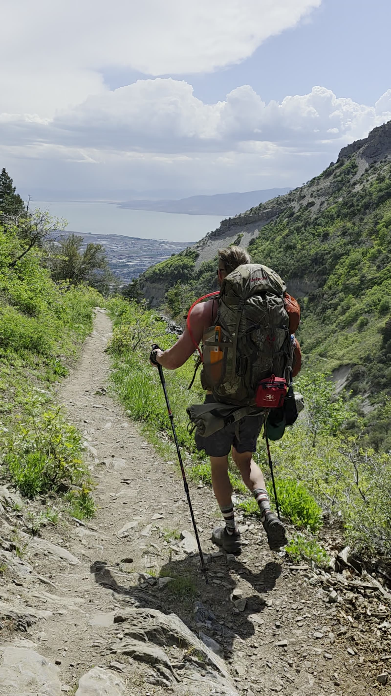 Backpacking down the trail with Utah Valley in the distance